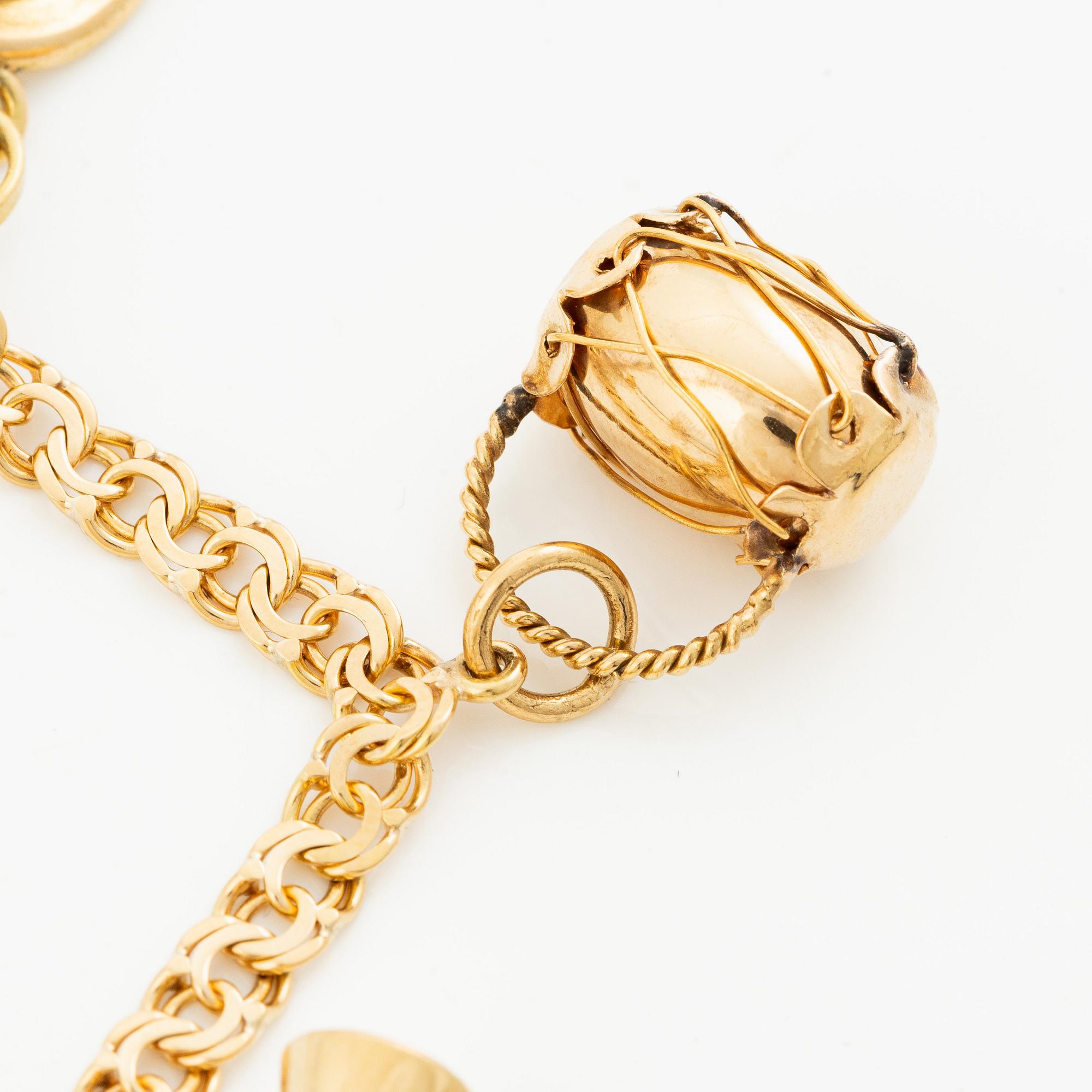 Bracelet, 18K gold bismarck link. With charms.