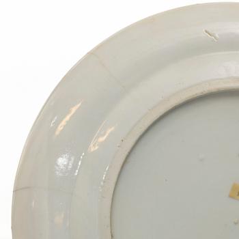 A matched set of 14 famille rose 'Canton' dinner plates, Qing dynasty, 19th century.