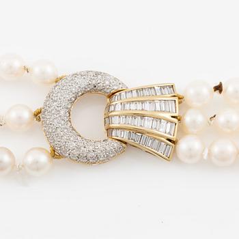 Pearl necklace, three strands of cultured pearls, clasp in 18K gold set with baguette and brilliant-cut diamonds.