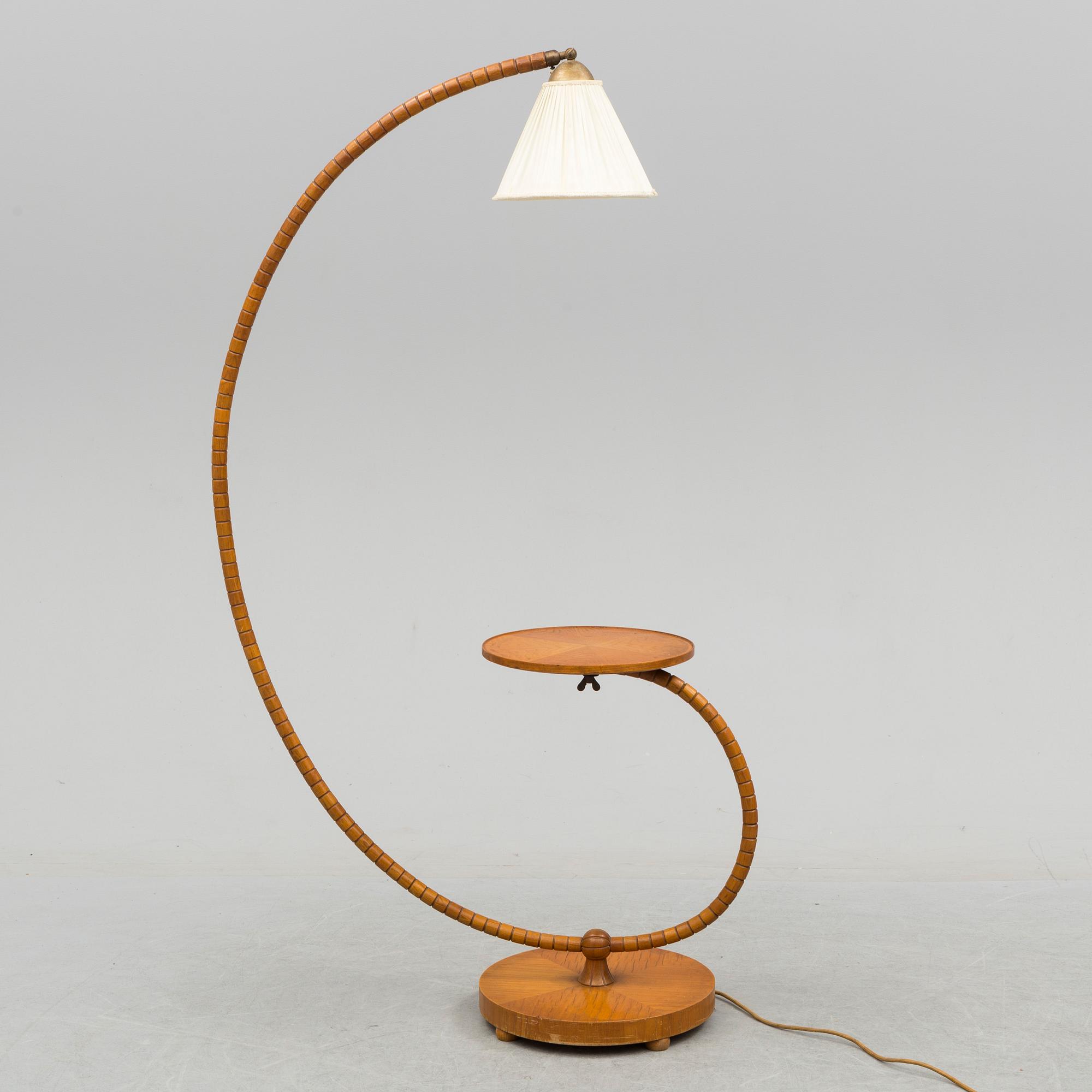 A first half of the 20th century floor lamp with table.