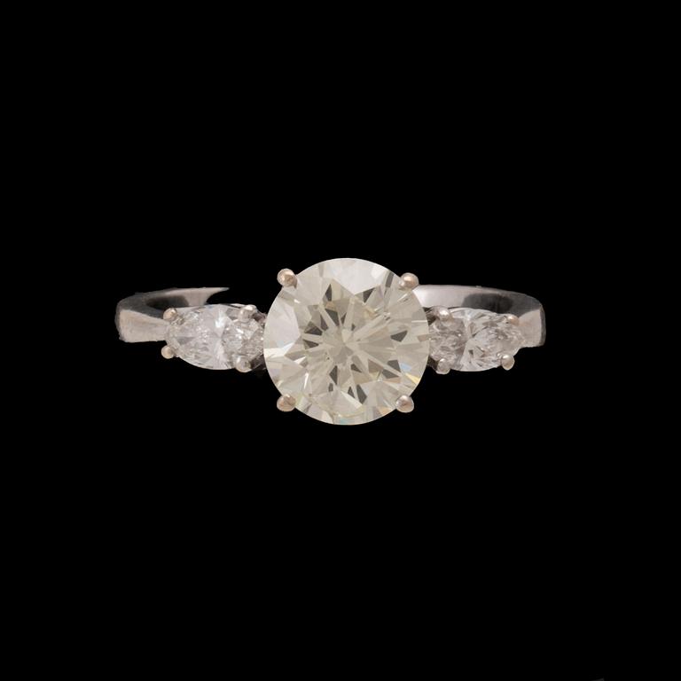 An 18K white gold ring set with one round brilliant-cut diamond and two marquise-cut diamonds.