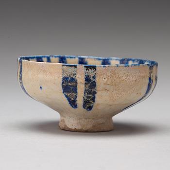 A BOWL, pottery with a white slip and underglaze blue decor, diameter ca 10 cm, Kashan, Persia/Iran early 13th century.