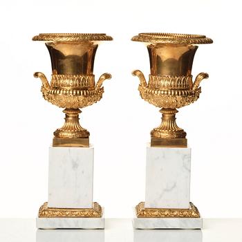 A pair of French 19th century gilded urns.