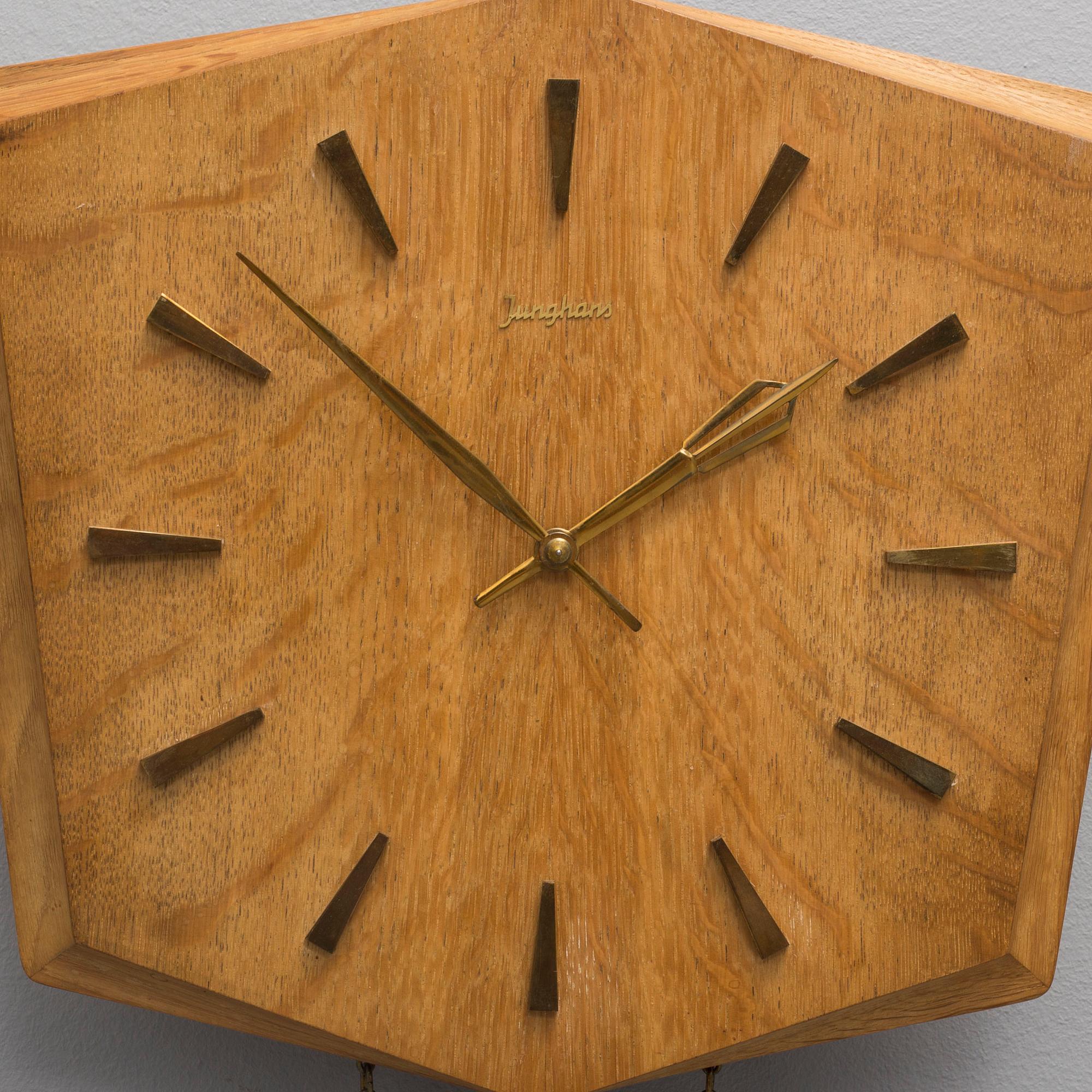 An oak veneered wall clock from the 1960s.