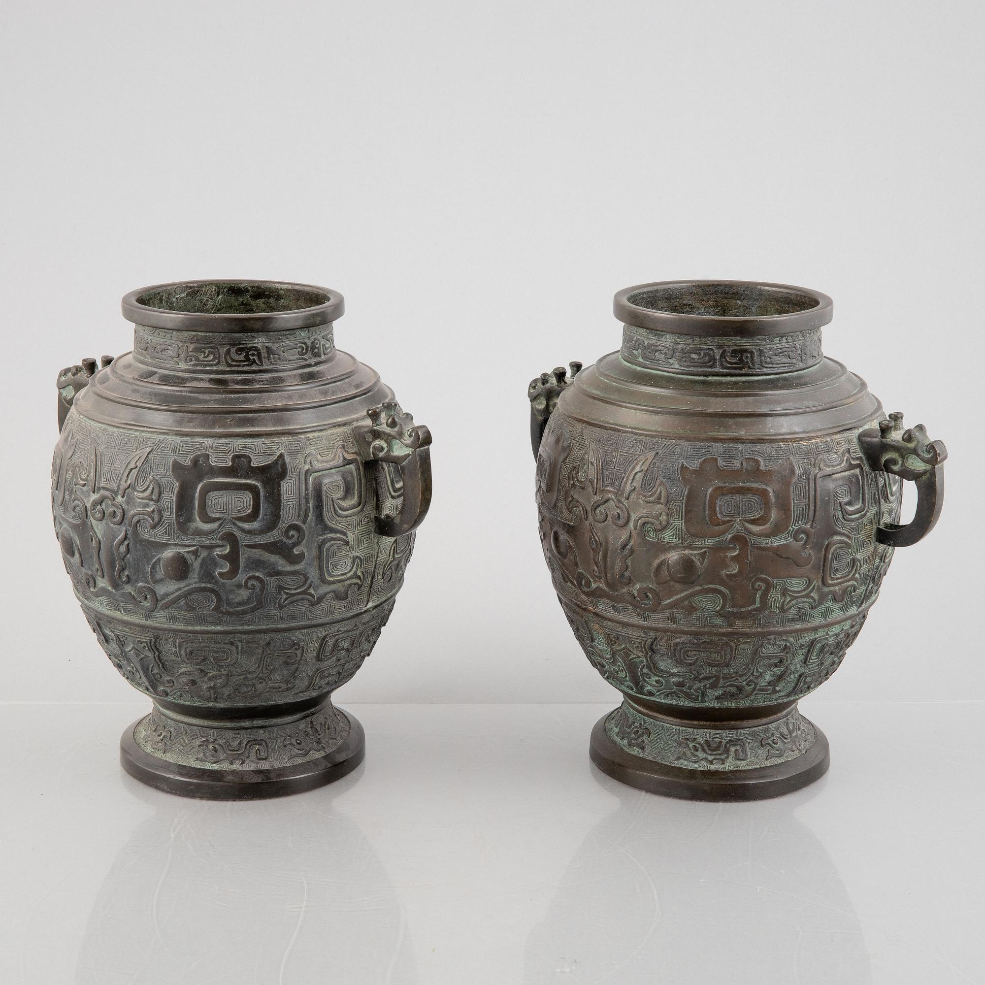 A pair of Chinese bronze urns, 20th century.