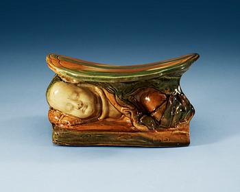 1626. A green and yellow glazed pillow, presumably Liao dynasty (907-1125).