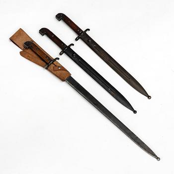 Three Swedish bayonets with scabbards.