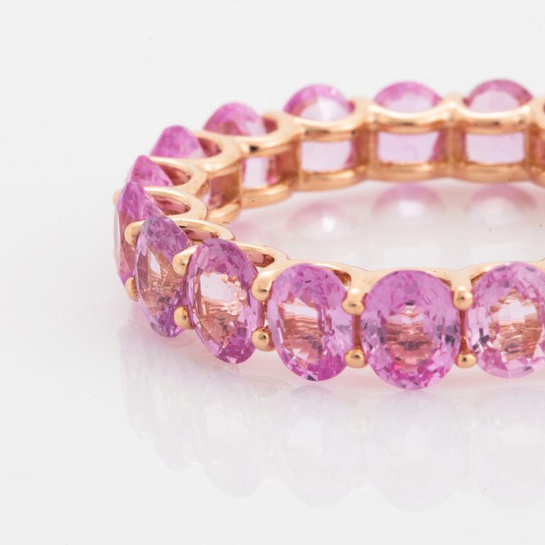 Oval faceted pink sapphire ring.