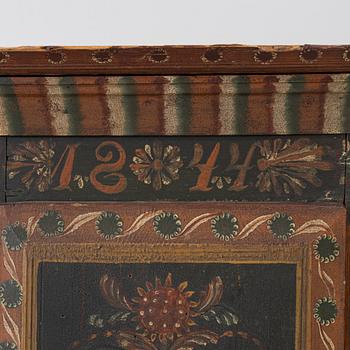 A corner hanging cabinet, dated 1844.