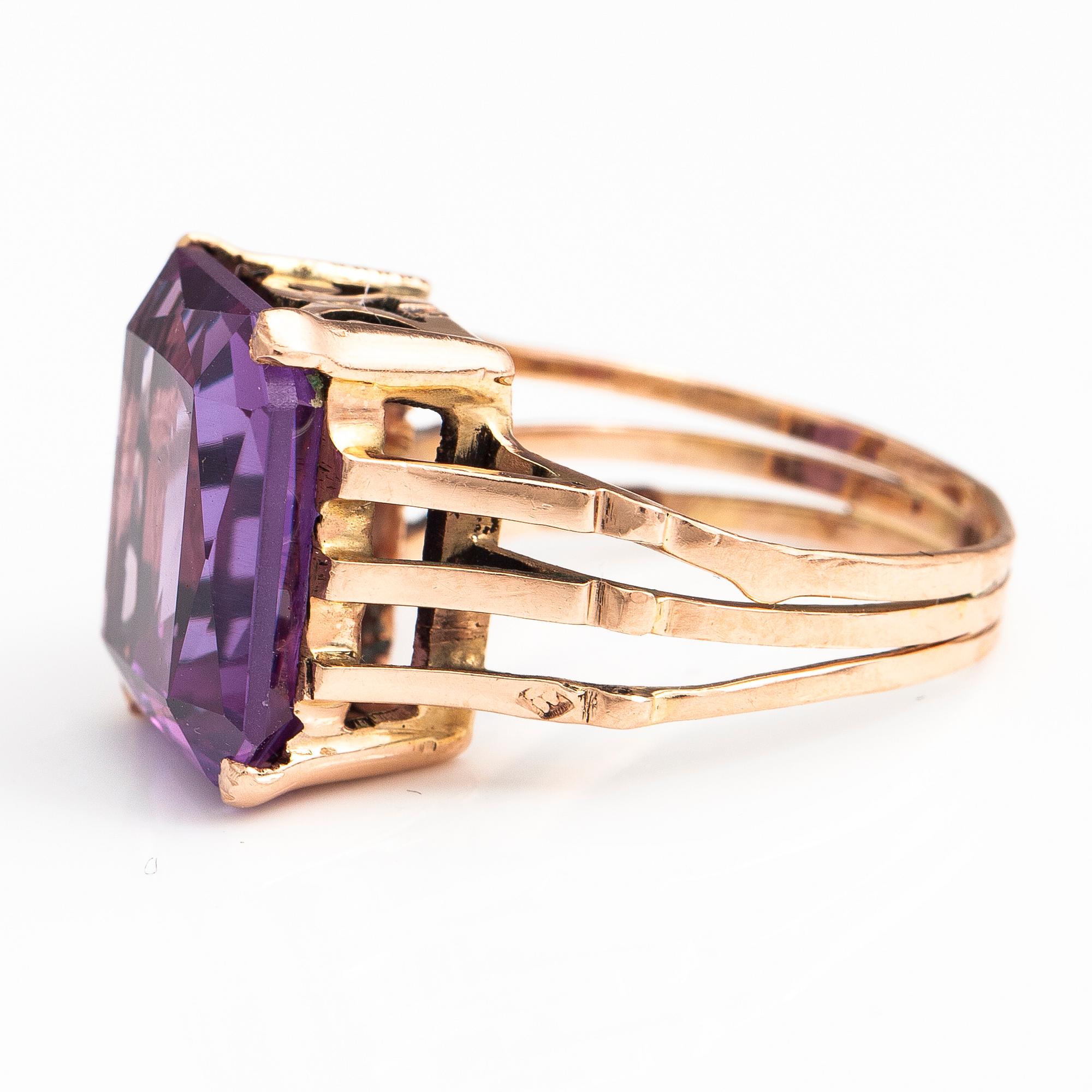 A 9-14K gold ring with a synthetic sapphire.