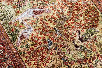 An Oriental figural silk rug, ca 126 x 83 cm.