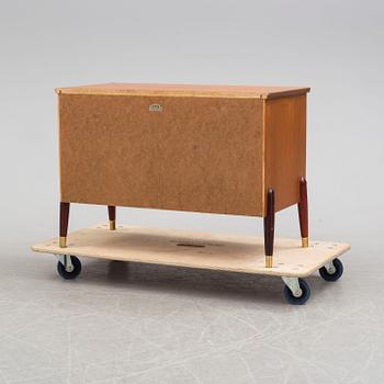 A 1950s teak veneer chest of drawers.