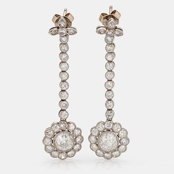 A pair of platinum earrings set with two old-cut diamonds with a total weight of ca 1.30 cts quality ca H vvs.