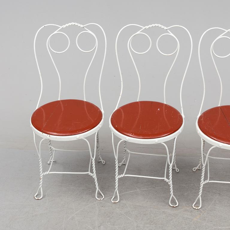 A garden table and four chairs, first half 20th century.