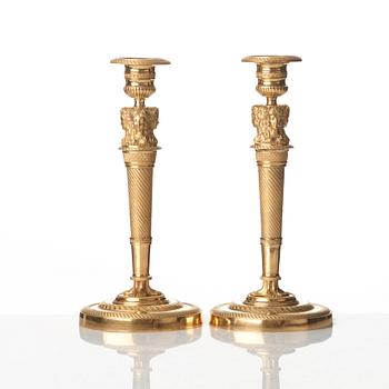 A pair of French Empire early 19th century gilt bronze candlesticks.