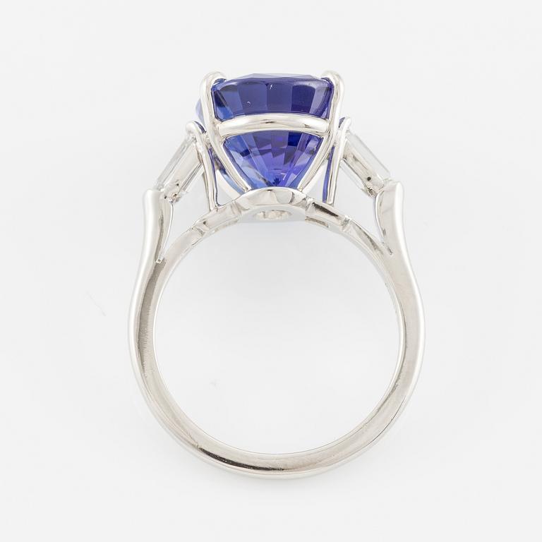 Ring, Fred Leighton platinum with an oval faceted tanzanite and fancy-cut diamonds.