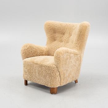 A 1940s lounge chair from Slagelse, in new sheepskin upholstery.