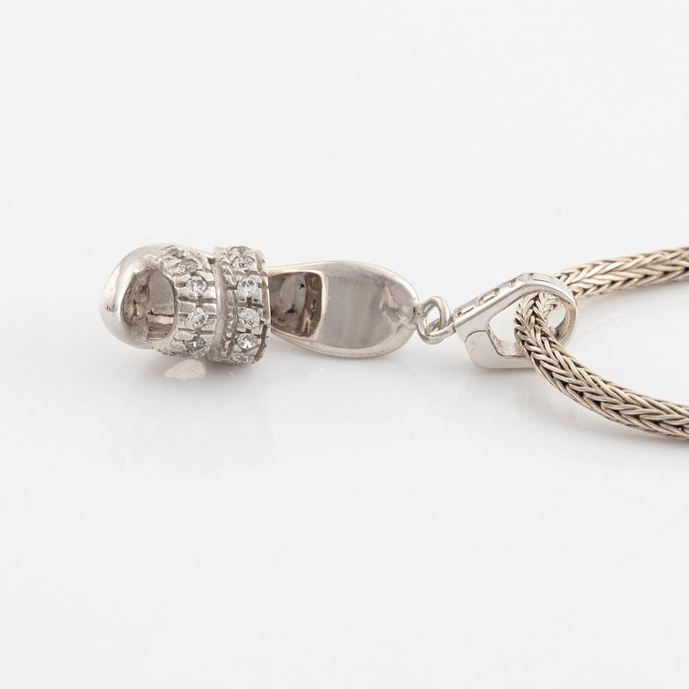 18K white gold shoe pendant with faceted white stones, silver chain.