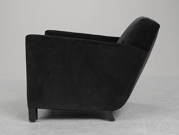 An Uno Åhrén black velvet and black stained birch sofa, by Firma Svenskt Tenn circa 1930.