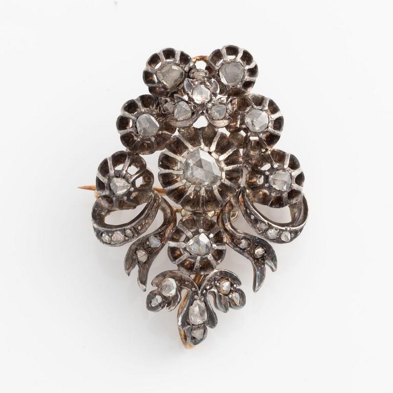 A silver brooch set with rose-cut diamonds.