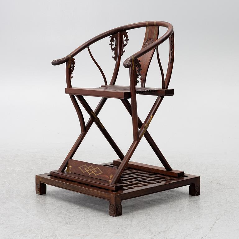 A Chinese hardwood folding chair, 20th century.