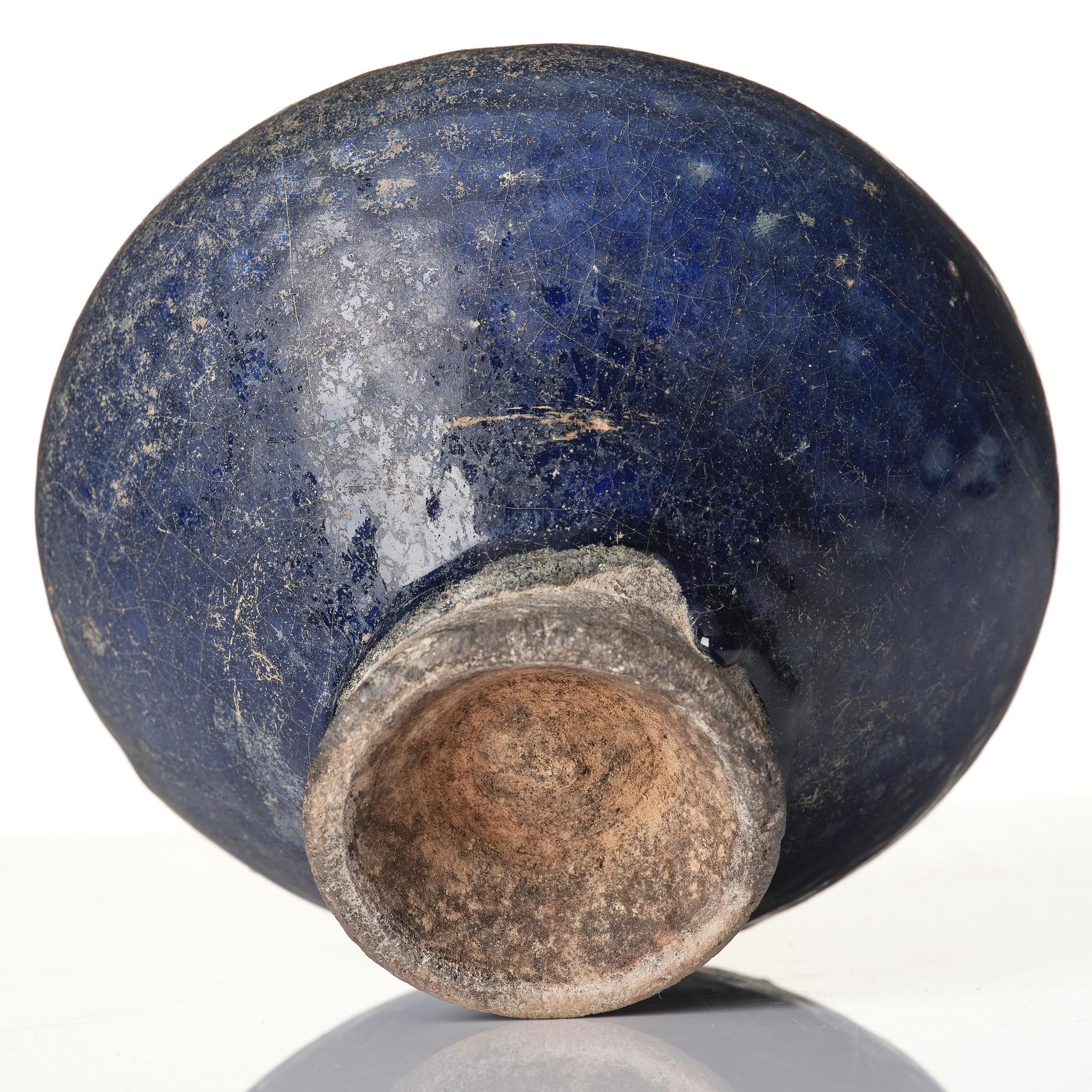 A blue-glazed Nishapur pottery Jug, Persia, 13th century.