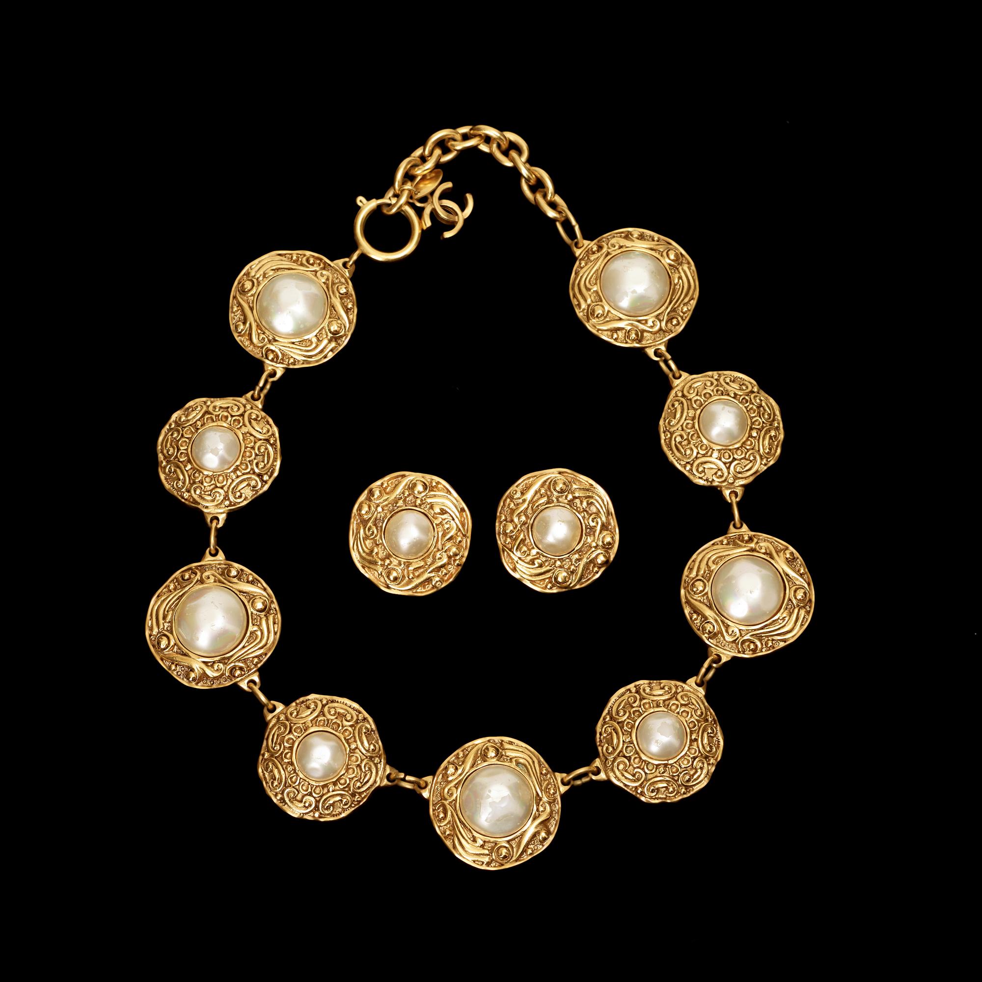 A necklace and a pair of earrings by Chanel.