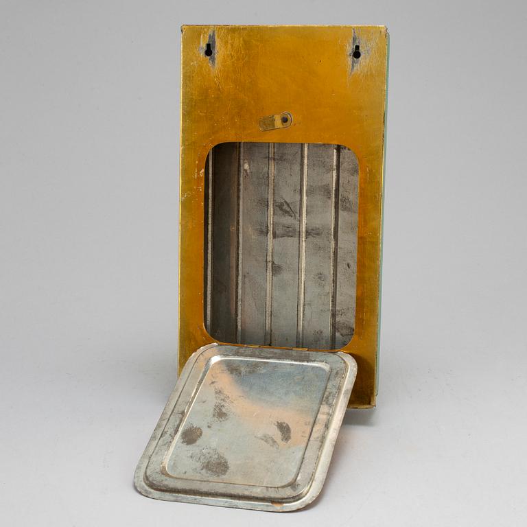 A metal board from the first half of the 20th century.