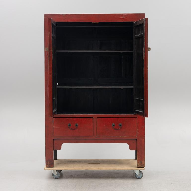 A red-lacquered cabinet, China, 20th century.