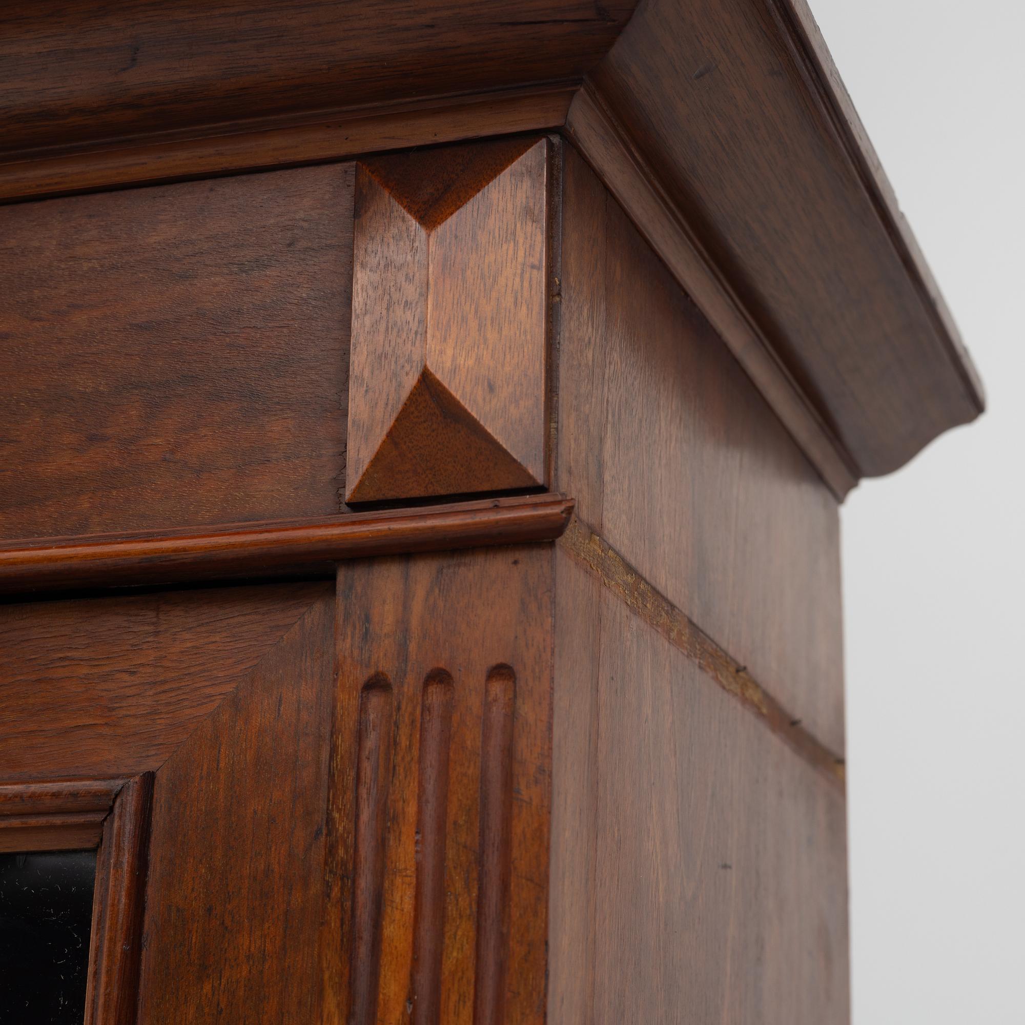 A two part mahogany cabinet, around 1900.