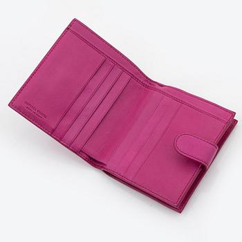 Bottega Veneta, a cerise leather wallet.