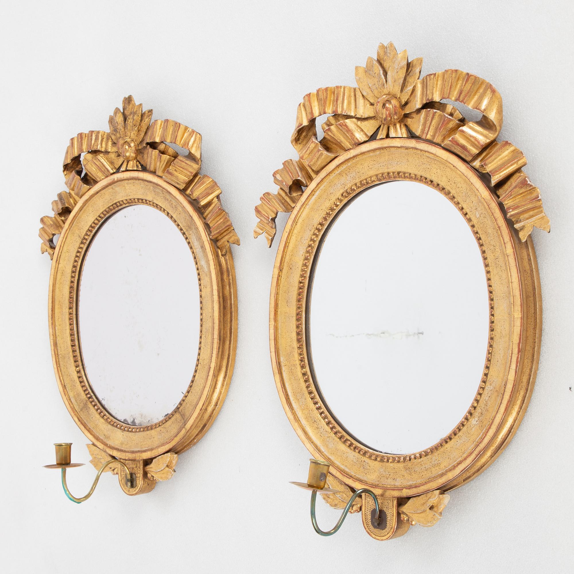 A pair of one-light Gustavian-style giltwood girandole mirrors, late 18th c /resp circa 1900.