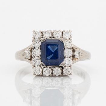 A platinum ring set with a faceted sapphire.
