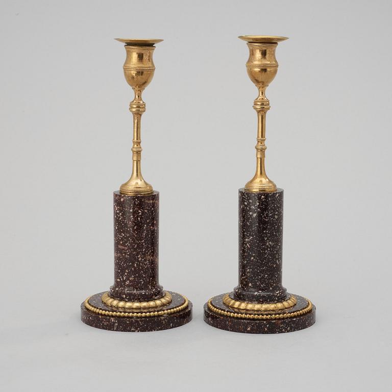 A pair of late Gustavian circa 1800 porphyry and gilt bronze candlesticks.