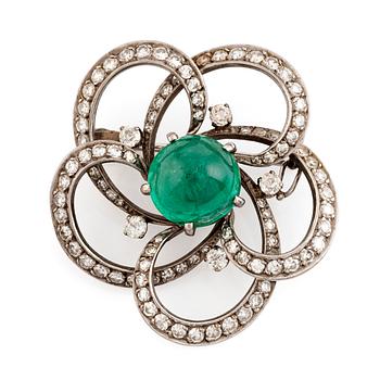 A white gold, cabochon cut emerald and diamond brooch.