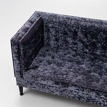 A contemporary velvet sofa by Shaun Clarkson.
