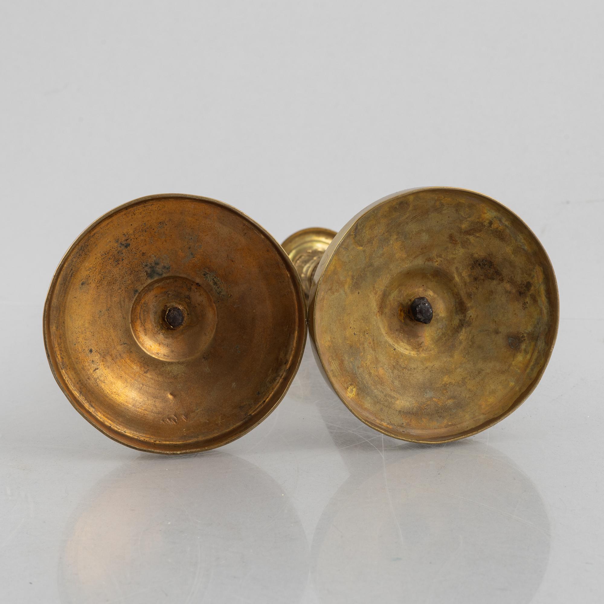 A pair of Empire gilt brass candle sticks, first half of the 20th century.