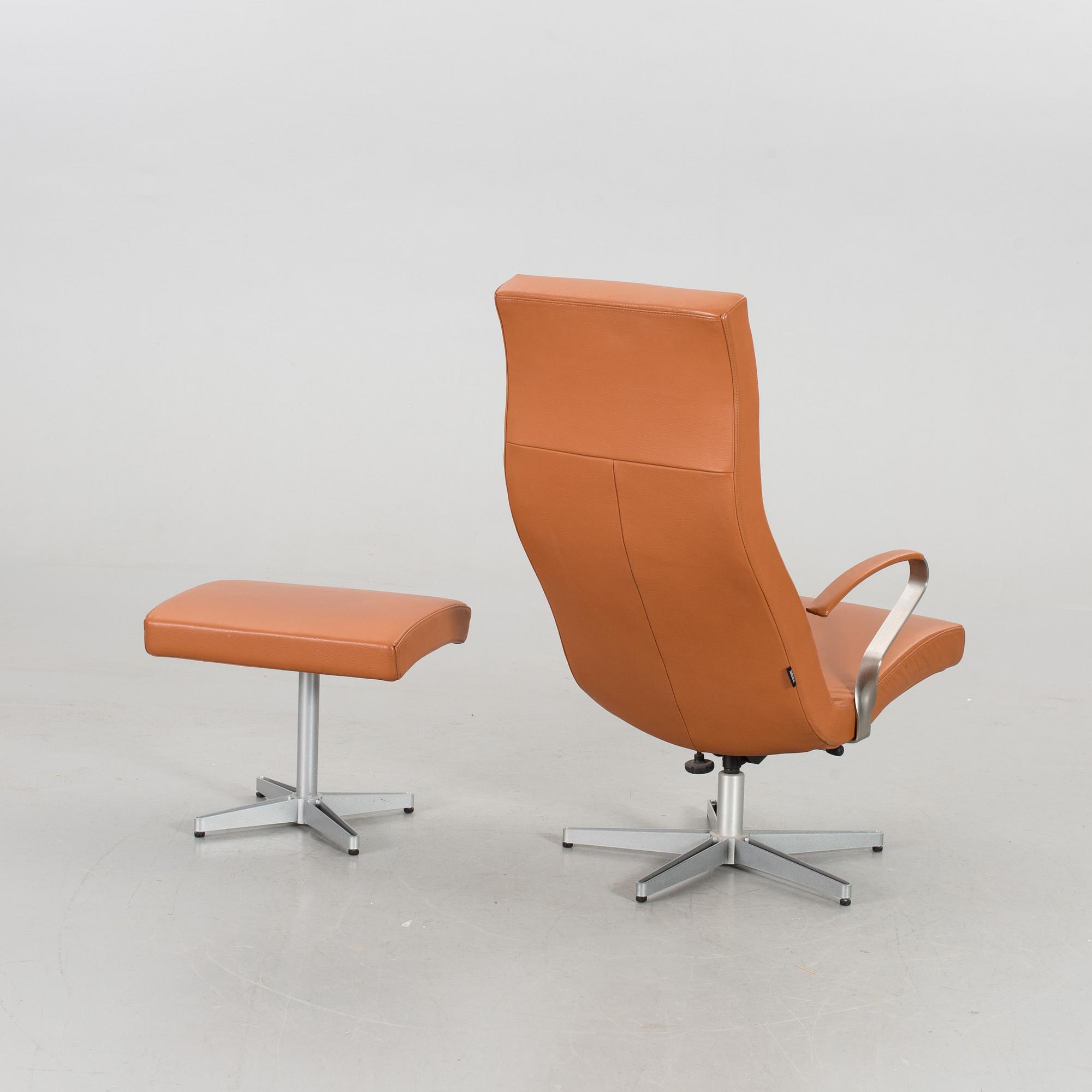 AN ARMCHAIR WITH STOOL MODEL "TWIST" DESIGNED BY JERKER ANDERSSON FOR SÖDERBERGS MÖBLER.