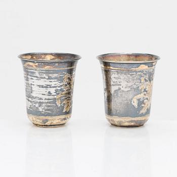 Four parcel-gilt silver beakers, Moscow 1870, 1876 and 1890.