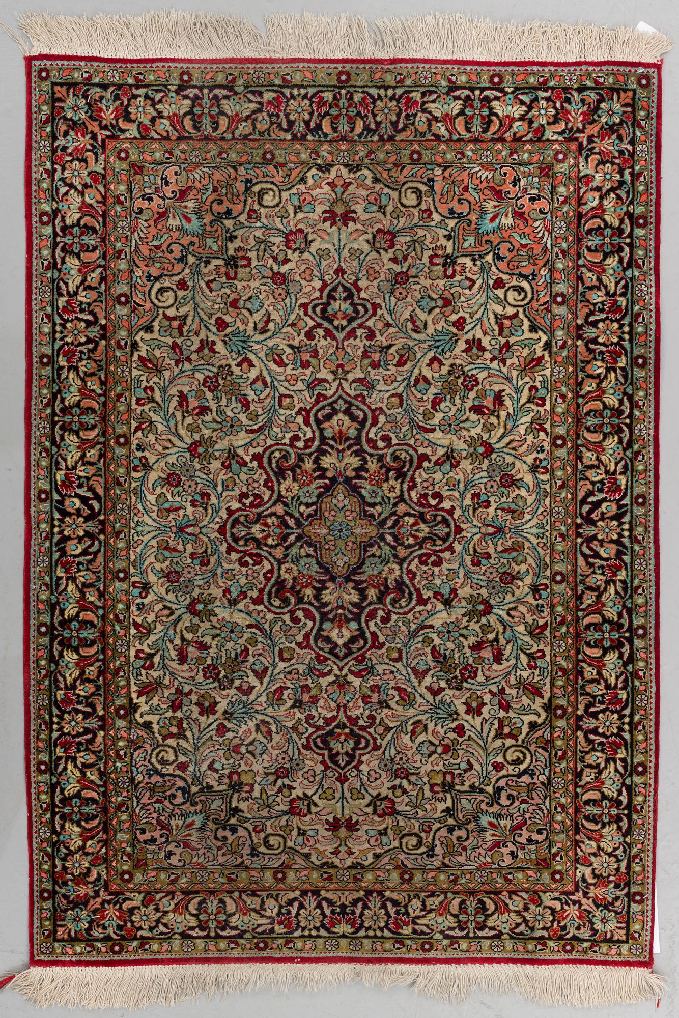 A silk Qum rug, around 114 x 80 cm.