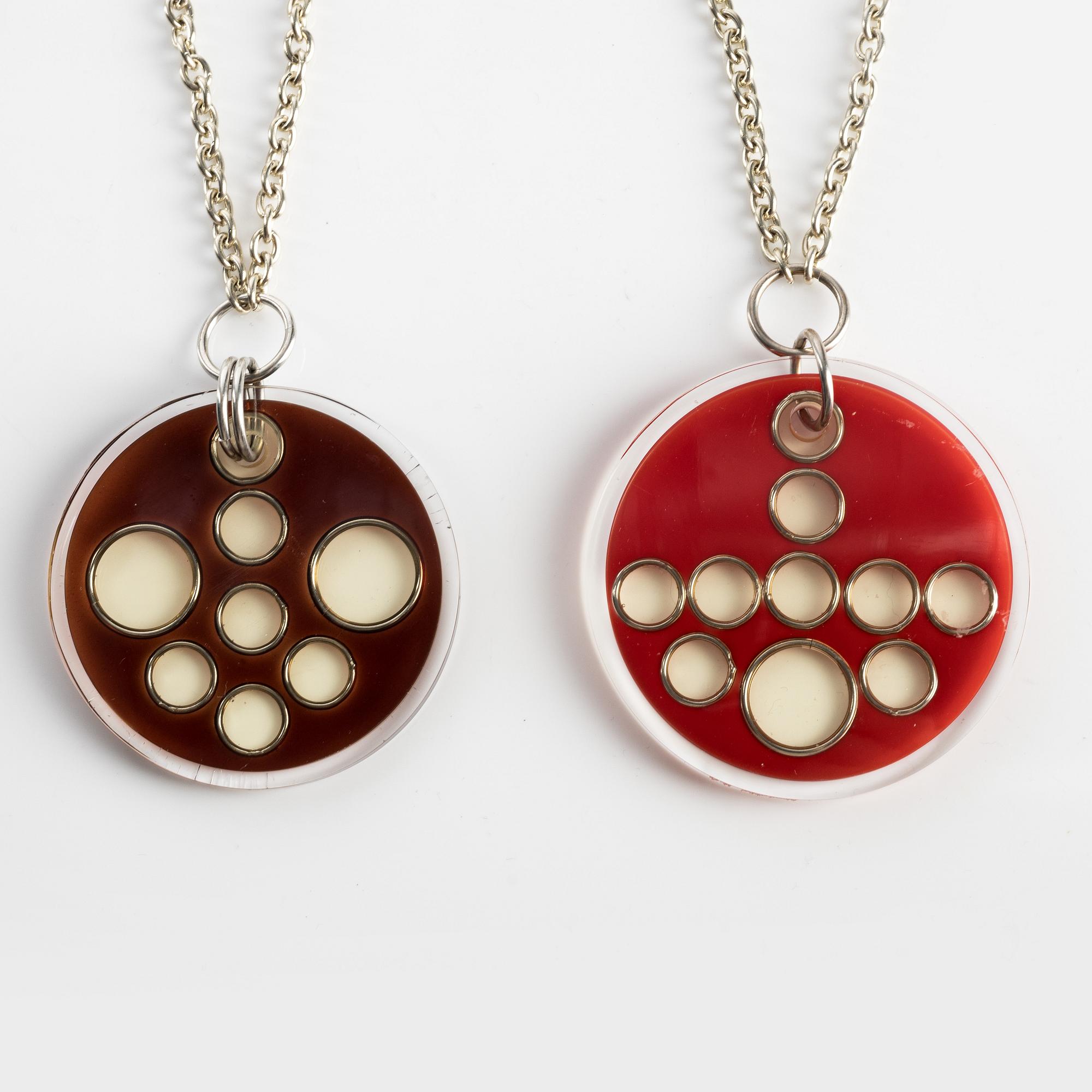 Necklaces, two pieces, acrylic plastic, with metal chains.