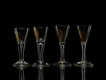 A set of four armorial wine goblets, 18th Century.