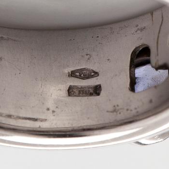 An 18K white gold ring with garnets and cordierites.