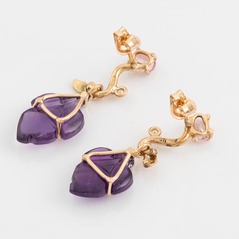 Earrings with cut amethysts, tourmaline, and small diamonds.