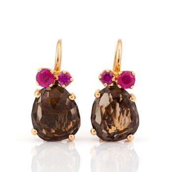 A pair of 'Bahia' earrings by Pomellato set with mixed-cut smokey quartz and rubies.