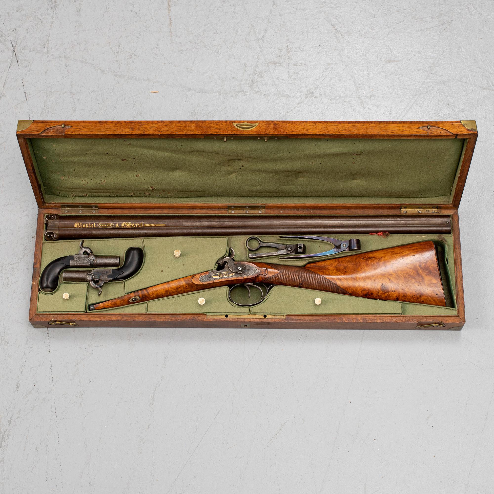 A cased double barreled percussion shotgun marked Gosset a Paris and a pair of percussion pistols marked Fni PAR LEPAGE.