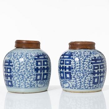 A pair of Chinese blue and white porcealin jars with wooden covers, Qing dynasty, 19th Century.