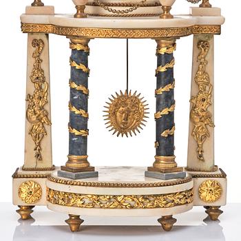 A Louis XVI gilt bronze and white and grey marble mantel clock.