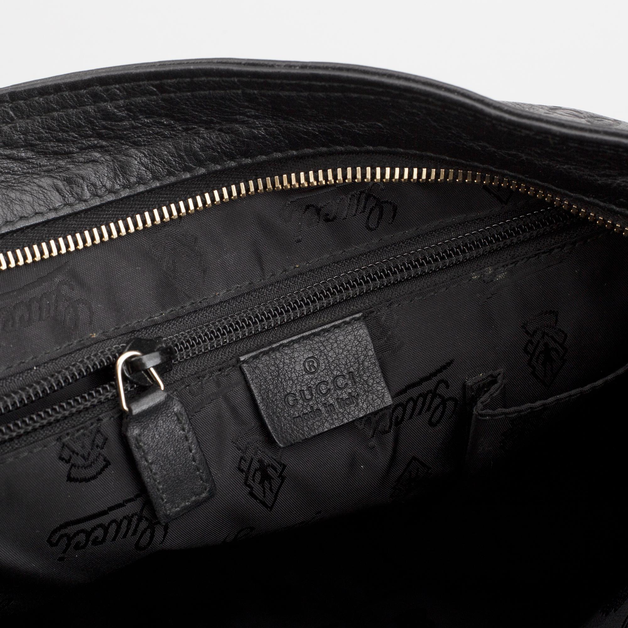 Gucci, a leather messenger bag.