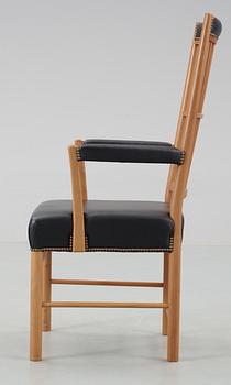 A Josef Frank cherrywood and black leather armchair by Svenskt Tenn, model 652.